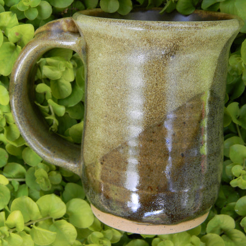 Photograph of a stoneware pottery mug in earthy browns